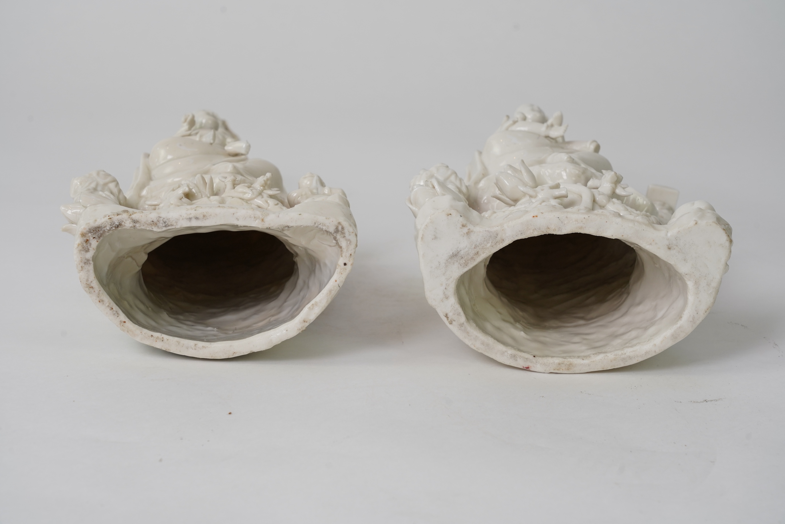 A pair of Chinese blanc de chine groups of Guanyin and children, 18th century